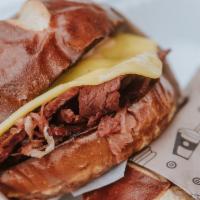 Reuben Sandwich · Thinly sliced house seitan, sauerkraut, provolone slice, and thousand island on a toasted pr...