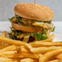 Double Decker Burger · Two vegan patties with thousand island, pickles, lettuce, and cheese sauce on a sesame bun.