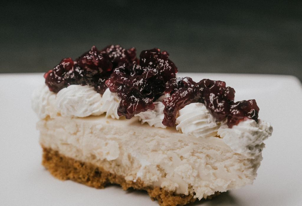 Cheese Cake · Housemade cheesecake with blueberry or strawberry sauce.