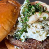 Surf & Turf Burger · half-pound beef patty, jumbo grilled shrimp, chimichurri sauce and remoulade slaw on a brioc...