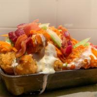 Buffalo Chicken Tots · Crispy tots topped with 3-cheese sauce, bleu cheese dressing, crispy buffalo chicken pieces,...