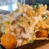 Truffle Mac & Cheese Tots · crispy tots topped with mac & cheese, bacon, herb ranch dressing, and green onions