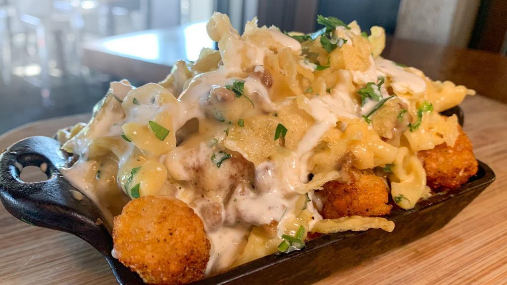 Truffle Mac & Cheese Tots · Crispy tots topped with truffle mac & cheese, herb ranch dressing and green onions