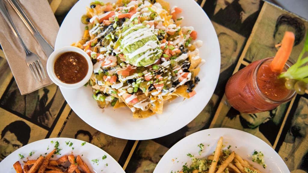 Nachos · House-made tortilla chips with organic black beans, vegan cheese, jalapeños, guacamole, green onions, vegan sour cream and fresh salsa. Try them with fries instead of chips! Add spicy Impossible ground beef for an additional charge. Vegan.