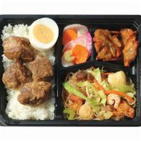 Pork Adobo Bento Bx · Served with Pancit Bihon, Fish Fritters, Pickled Radish, and Rice.