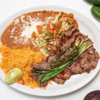 Carne Asada Plate · Grilled beef steak, served with lettuce, tomato,  green onions. Tortillas and Beans and Rice