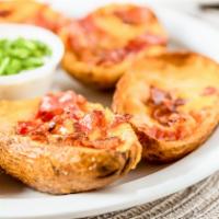 Potato Skins · Six potato skins stuffed w/ cheddar bacon. Served w/ ranch and chives.