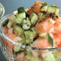 Salad Shirazi · Persian cucumber, tomato, onion, lime juice, and mint. Served with bread.
