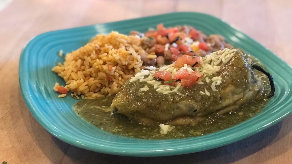 Chile Relleno · Roasted pasilla pepper stuffed with three cheeses, fried in eggs and smothered in oven roasted tomatillo sauce add enchiladas for an additional charge. Served with rice and choice of black or pinto beans.
