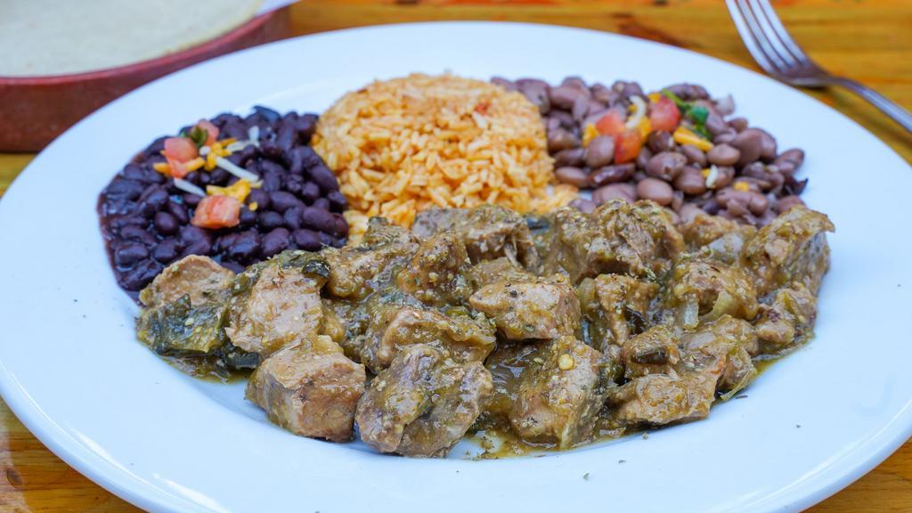 Pork Chile Verde · Oven roasted pork cooked with peppers, onions, tomatillos, garlic and Mexican spices. Served with rice, tortillas and choice of black or pinto beans.