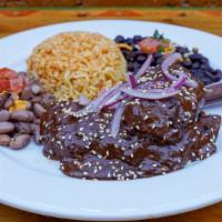 Chicken Mole Plate · Tender grilled chicken breast smothered in mole sauce, topped with lime pickled onion and aj...