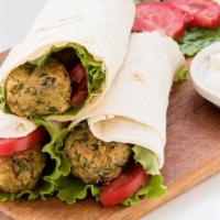 Vegan Buffalo Falafel Wrap · Classic mediterranean wrap with chickpea fritters, lettuce, tomatoes, onions, cucumber based...