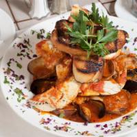 Cioppino Rosso · Cioppino with steamed crab legs, mussels, manila clams, calamari, shrimp, and covered with o...