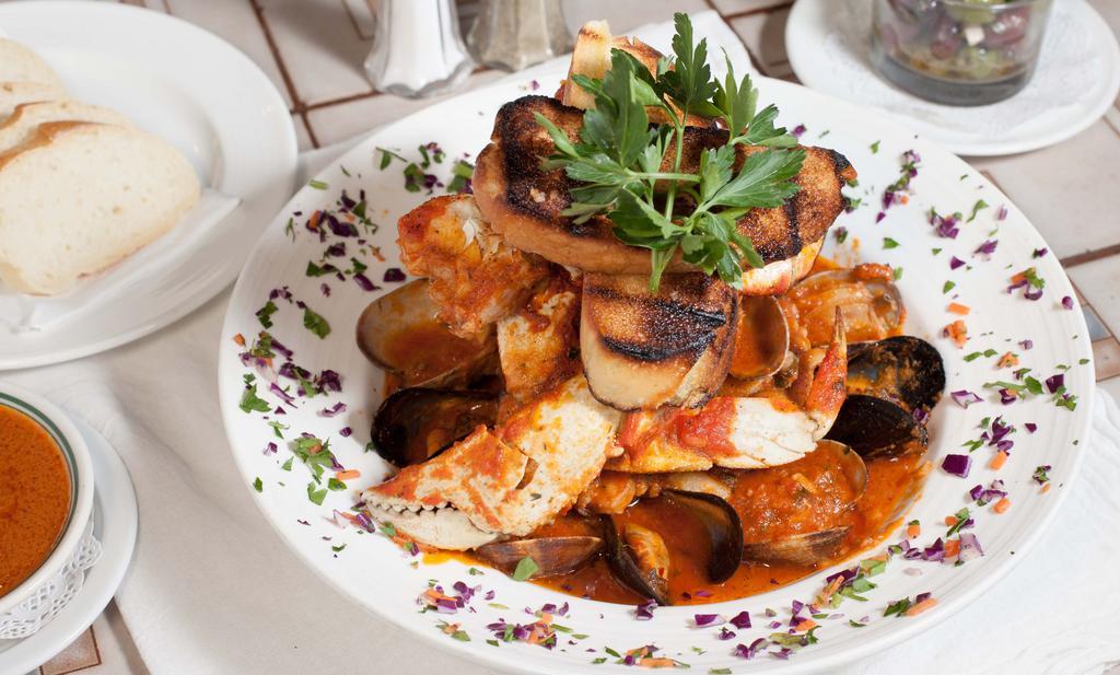 Cioppino Rosso · Cioppino with steamed crab legs, mussels, manila clams, calamari, shrimp, and covered with our house marinara sauce.