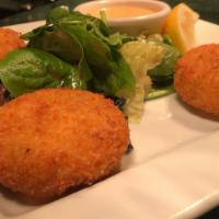 Crab Cakes · 3 crispy crab cakes served with a spicy aioli & a side of greens.