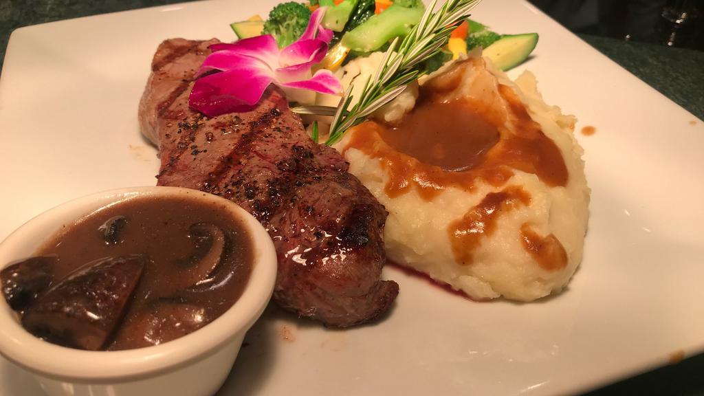 New York Steak · 12 oz. of New York steak with a gorgonzola cream sauce, served with mixed vegetables and garlic mashed potatos.