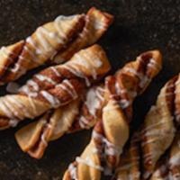 Cinnamon Twists · Our famous twists, rolled in a brown and white sugar cinnamon mixture and topped with a deli...