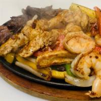 Fajitas Mixtas · Steak and shrimp chiken fajita mixed with bell pepper and onions served with beans, salad, p...