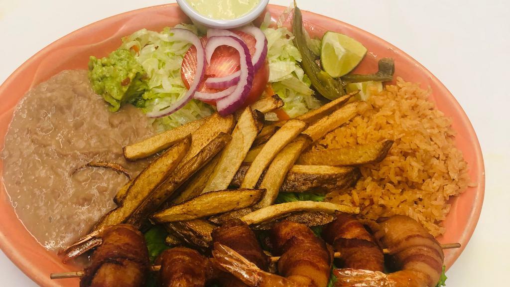 Camarones Momia · Bacon wrapped jumbo shrimp served with rice, beans, salad, French fries, and guacamole.