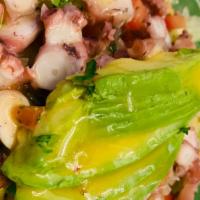 Tostada de Pulpo · Tostada with diced tomatoes, onion, and cucumber octopus.