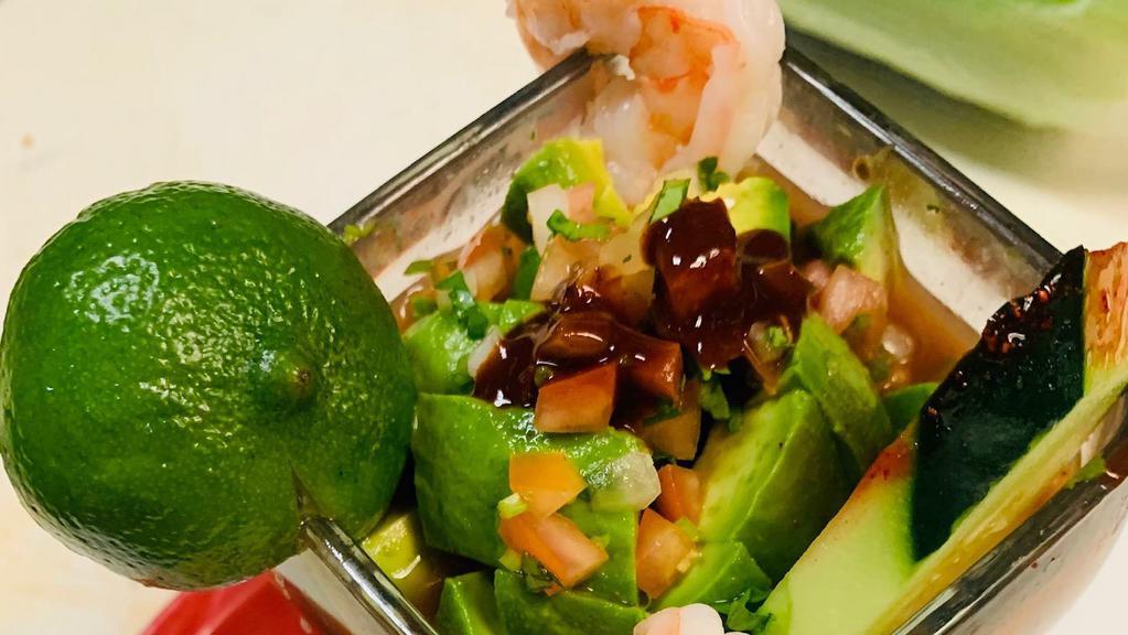 Coctel de Camaron Y Ostion · Shrimp and oyster cocktail. Served with tomato, onion, cilantro, avocado, and cucumber.