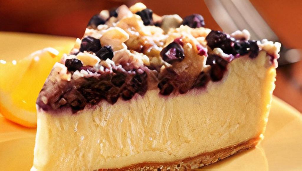 Lemon Blueberry Cheesecake · Creamy lemon cheesecake topped with blueberries and brown sugar crumbs