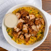 Chicken Kebab Rice Bowl · Turmeric spiced Basmati rice simmered with tomatoes, garlic, onions, mint, and parsley. Topp...