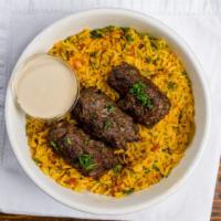 Beef Kebab Rice Bowl · Turmeric spiced Basmati rice simmered with tomatoes, garlic, onions, mint, and parsley. Topp...