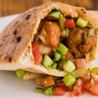 Pita Chicken · Grilled chicken, hummus, cucumber, tomato, pickles, and tahini