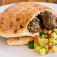 Pita Beef Kebab · Ground beef and lamb kebab, hummus, cucumber, tomato, pickles, and tahini