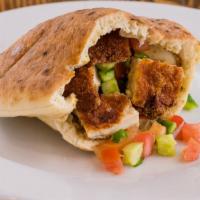 Pita Chicken Schnitzel · Breaded and fried chicken breast, hummus, tomato, cucumber, and pickles