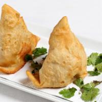Vegetable Samosa · Two crisp and spiced vegetable puffs filled with potatoes and peas.
