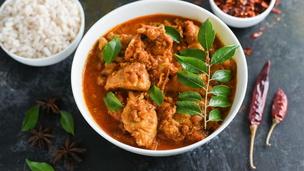 Mutton Kulambu · Mutton curry made in a pressure cooker with seasoned mutton and aromatic spices.