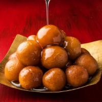 Gulab Jamun · Three pieces of fried dough balls soaked in a sweet, sticky sugar syrup.
