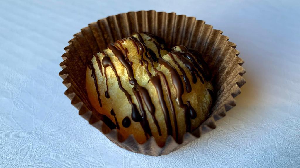 Mini Cream Puffs · 12 Choux pastry filled with Bavarian cream and topped with a drizzle of dark chocolate.