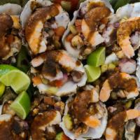 Ostiones Preparados Dozen · 12 Raw oysters, shrimp ceviche, cooked shrimp, Octupus, avocado, lemon and house black sauce...