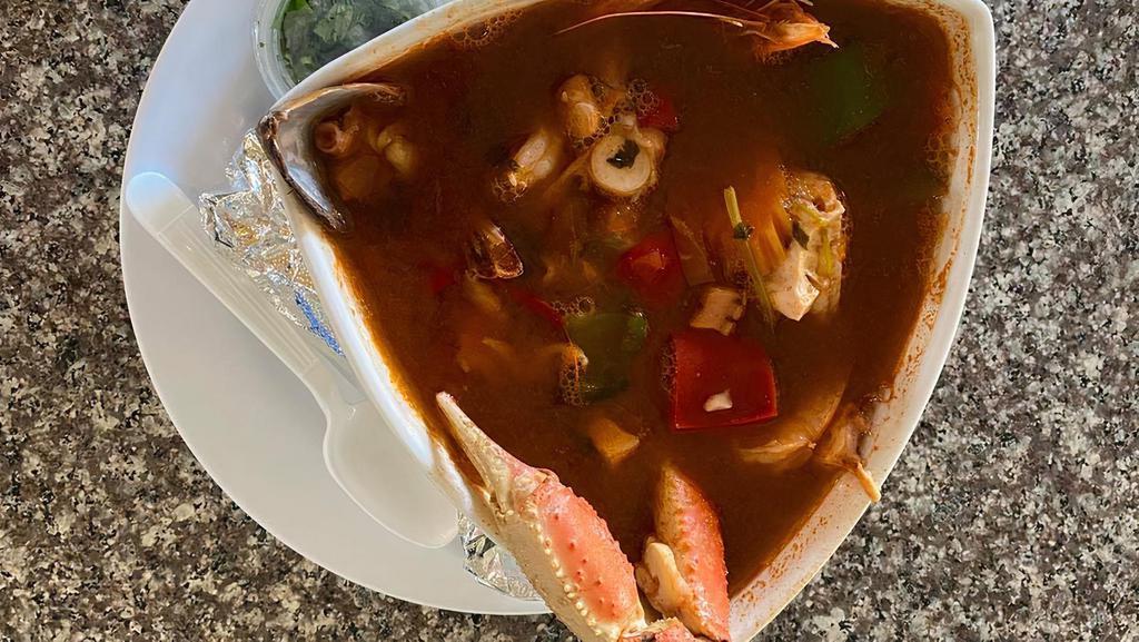 Caldo 7 Mares · Hot seafood soup, green mussels, octopus, head on shrimp, head less shrimp , tilapia fish fillet, crab legs, bell pepper, carrots, serve with corn tortillas, lemon, onions and cilantro on the side.