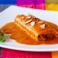 Enchiladas Guajillo · Tow corn tortillas filled with meat or cheese topped with guajillo sauce and sliced almonds....