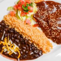 Pollo En Mole · Breast of chicken simmered in mole sauce with sesame seeds. *** PLEASE NOTE: Pinto Beans and...