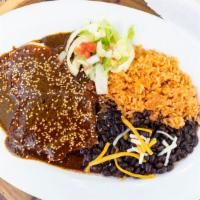 Pollo En Mole · Breast of chicken simmered in mole sauce with sesame seeds on top and served with flour tort...