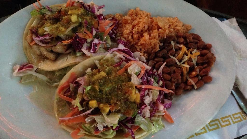 Fish Tacos Snapper · A traditional classic! Fish simmered in our fresh homemade tomatillo green sauce with fresh fruit, coleslaw and salsa fresca.