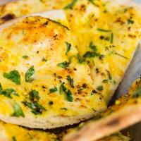 Garlic Naan · Soft bread stuffed with garlic & fresh cilantro & baked in our tandoor.