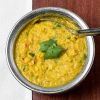 Dal Tadka · Yellow lentils stewed with onions, tomatoes, and garlic, tempered with hot oil, red chilies ...