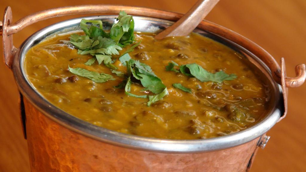 Dal Makhani · Black lentils and red kidney beans simmered with tomatoes, ginger, garlic and finished with cream