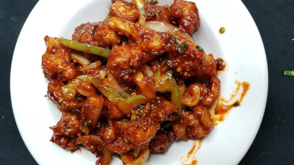 Chicken Chili · Boneless pieces of chicken battered & lightly fried, sautéed with bell peppers, onions, & fresh green chilies in a special blend of herbs & spices.