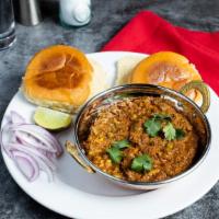 Keema Pav · Seasoned ground lamb, onions, green peas, and spices served with two pieces of Indian bread.
