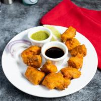 Chicken Pakora · Fresh sliced chicken breast dipped in a spicy batter and fried until golden crisp.