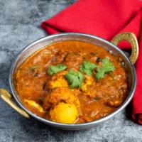 Egg Curry · Farm eggs cooked in an Indian masala curry and garnished with ground spices.