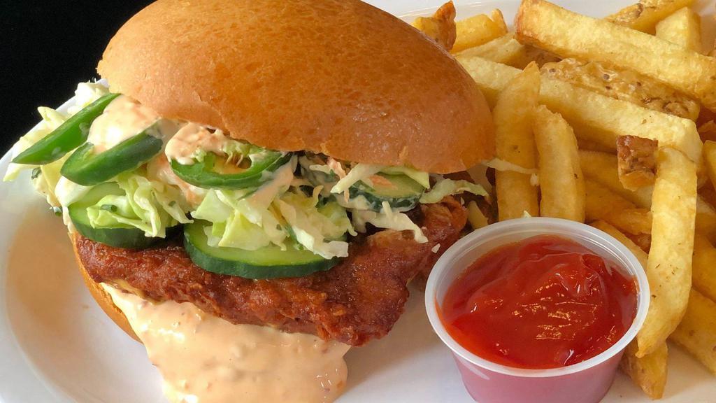 Banh Mi Fried Chicken Sandwich · Buttermilk fried chicken, carrot, cilantro slaw, cucumber, jalapeños, sriracha mayonnaise, and served on a toasted bun.