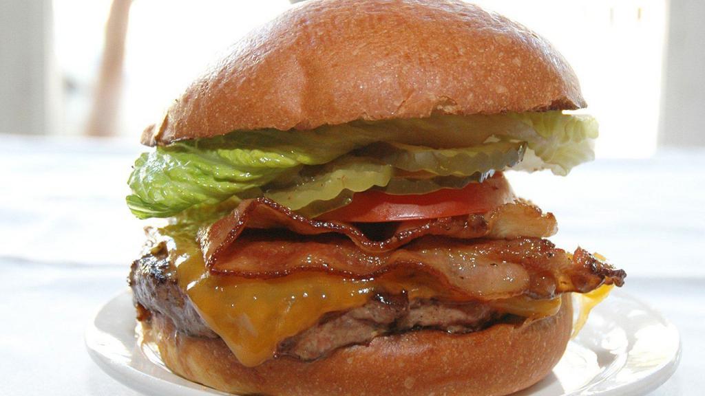 The Iowa Burger · Bacon and Cheddar cheese served on a perfect brioche bun with caramelized onions, chipotle remoulade, pickles, tomato and lettuce. Add small fries with curry ketchup for an extra charge.